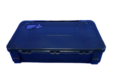 A black hard plastic storage case with a blue and white Meiho logo on the lid, resting on a blue background with a faint Meiho Tackle Boat watermark pattern.