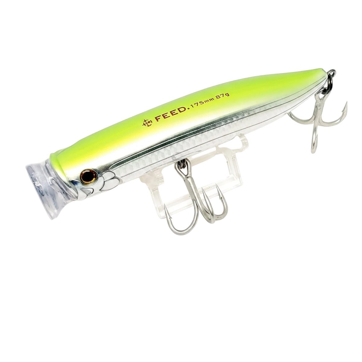 A silver and neon yellow-green hard fishing lure with two treble hooks, displayed on a clear stand against a white background. The brand name 'FEED' is printed on the side.